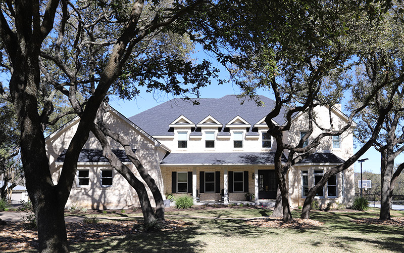 southern ranch home with white siding and blue shingles